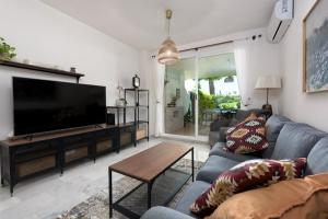 a living room with a large flat screen tv at Casa Patagonia in Manilva