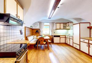 a kitchen with a table and a dining room at Apart Hennewinkl in Oetz +31 photos