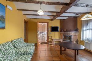 a living room with a couch and a table at Cuatro Torres in Campillo