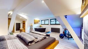 a bedroom with two beds and a blue wall at Apart Hennewinkl in Oetz