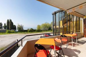 a balcony with tables and chairs on a building at Brezza del lago in Desenzano del Garda