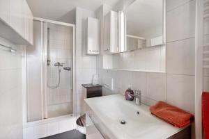 a white bathroom with a sink and a shower at Ferienhaus Tanneberg in Tanneberg +34 photos
