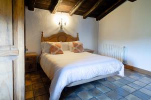 a bedroom with a large white bed in a room at Pagorriaga in Beasain