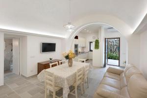 a living room with a table and a couch at Villa Degli Dei in Agerola