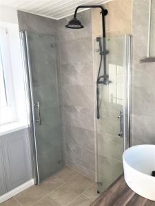 a bathroom with a shower with a glass door at Haus Sonnenschein in Janneby