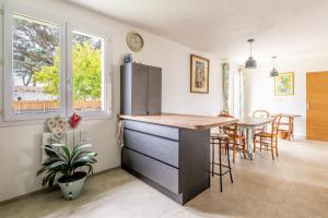 a kitchen and dining room with a counter and a table at Ker Pathabac in Préfailles +14 photos