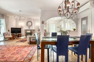 a dining room and living room with a table and chairs at Villa Shalimar Moraira in Teulada
