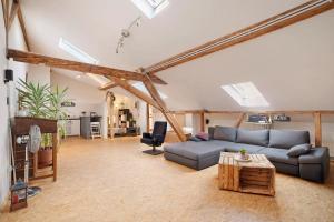 a living room with a couch and a table at Loft Sven in Baden-Baden