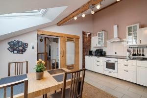 a kitchen with a wooden table and a dining room at Loft Sven in Baden-Baden