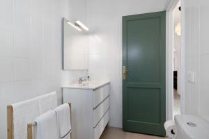 a bathroom with a green door and a sink at Los Alisios del Patron in Playa Honda +15 photos