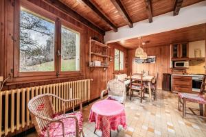 a kitchen with wooden walls and a table and chairs at Chalet Franclair in Samoëns