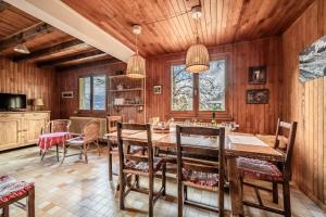 a dining room with a large wooden table and chairs at Chalet Franclair in Samoëns +28 photos