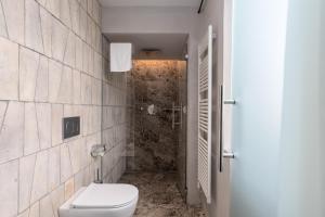 a bathroom with a toilet and a shower at Suite Fattoressa in San Gimignano +16 photos