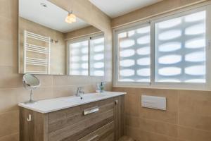 a bathroom with a sink and a mirror at Top first line apartment Altea in Altea +18 photos