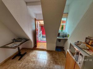 a view of a kitchen with a table in a room at Wohnung 2 in Burghaslach