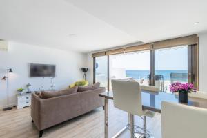 a living room with a couch and a table at Top first line apartment Altea in Altea