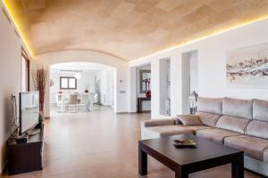 a living room with a couch and a table at Can Vadell in Calonge