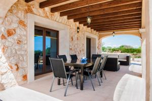 an outdoor dining room with a table and chairs at Can Vadell in Calonge