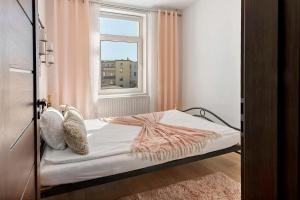 a small bedroom with a bed and a window at Haus Gera in Gera