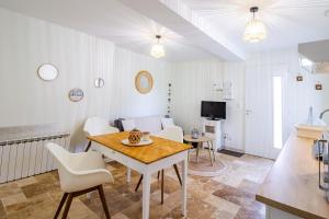 a living room with a table and chairs and a television at Appartement La Pierre in Saint-Médard-de-Mussidan