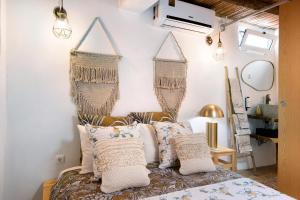 a bedroom with a bed with two baskets on the wall at Quinta do Silêncio T4 in Tavira +26 photos