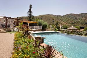 a swimming pool in front of a house at Quinta do Silêncio T4 in Tavira