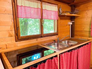 a kitchen with a sink in a log cabin at Le sorgenti - Chalet 57 in Palazzuolo sul Senio +28 photos