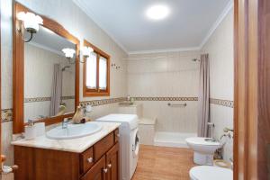 a bathroom with a sink and a toilet and a tub at Casa Dayaday in Puerto del Rosario +36 photos