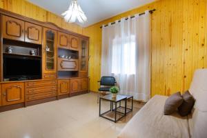 a living room with a couch and a tv at Casa Dayaday in Puerto del Rosario