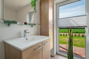 a bathroom with a sink and a large window at Gästehaus Anna in Suhle +82 photos