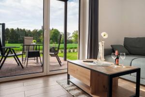 a living room with a couch and a table at Gästehaus Anna in Suhle