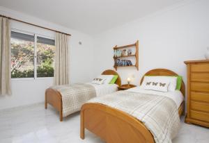 a bedroom with two beds and a window at Casa Mcelroy in Tías +20 photos