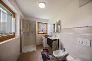 a bathroom with a sink and a toilet and a shower at Tschafon Oberparnaihof in Collepietra +14 photos