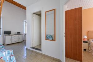 a room with a mirror on the wall at Il Quadrifoglio 3 in Procchio