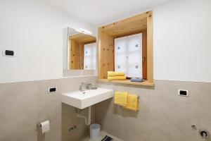 a bathroom with a sink and a mirror at Tea da Anna e Luigi in Livigno +18 photos