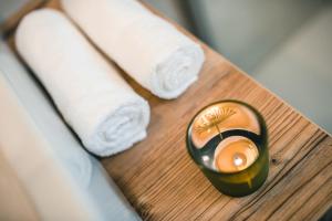 a candle on a table next to rolls of toilet paper at Chalet La Flüta Primula in La Valle