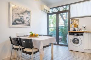 a kitchen with a dining room table with chairs at Casa Sunny in Port de Soller +20 photos
