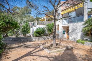 a house with a tree in the middle of a driveway at Casa Sunny in Port de Soller