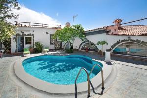 a swimming pool in front of a house at Finca Fani 2 in Agüimes +17 photos