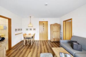 a living room with a couch and a table at Fewo Brünnstein - Nr 44 Pool, Sauna in Oberaudorf