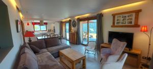 a living room with a couch and a table at Morzine Panoramic in Morzine