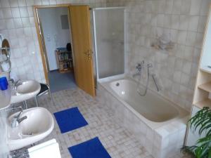 a bathroom with a tub and a toilet and a sink at Ferienwohnung Moog in Steinach +15 photos