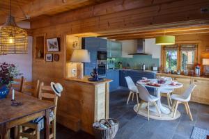 a kitchen and dining room with a table and chairs at Chalet Bachal in Manigod