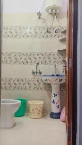 a bathroom with a sink and a toilet at Tungnath View Homestay in Sari