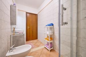 a bathroom with a sink and a toilet and a shower at La Casa Di Simba A Piombino in Piombino +25 photos