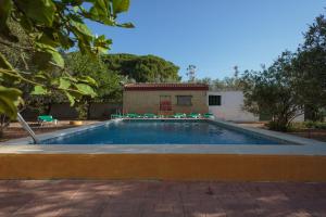 a swimming pool in a yard with a building at Villa Los Pinos in Marchena