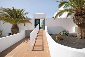 a staircase leading to a house with palm trees at Noaian in Puerto del Carmen