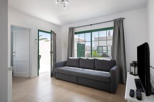 a living room with a couch and a tv at Noaian in Puerto del Carmen
