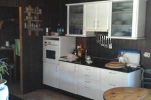 a kitchen with white cabinets and a white refrigerator at Chalet Rural Marian in Santa Maria de Guia de Gran Canaria