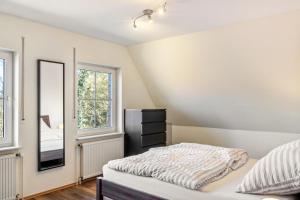 a bedroom with a bed and a mirror at Friesenwald in Zetel